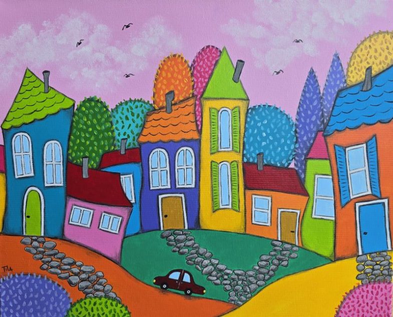 Whimsical town of tall colorful houses on rolling green and orange hills, with stone paths and a small black car on the road under a pink sky.